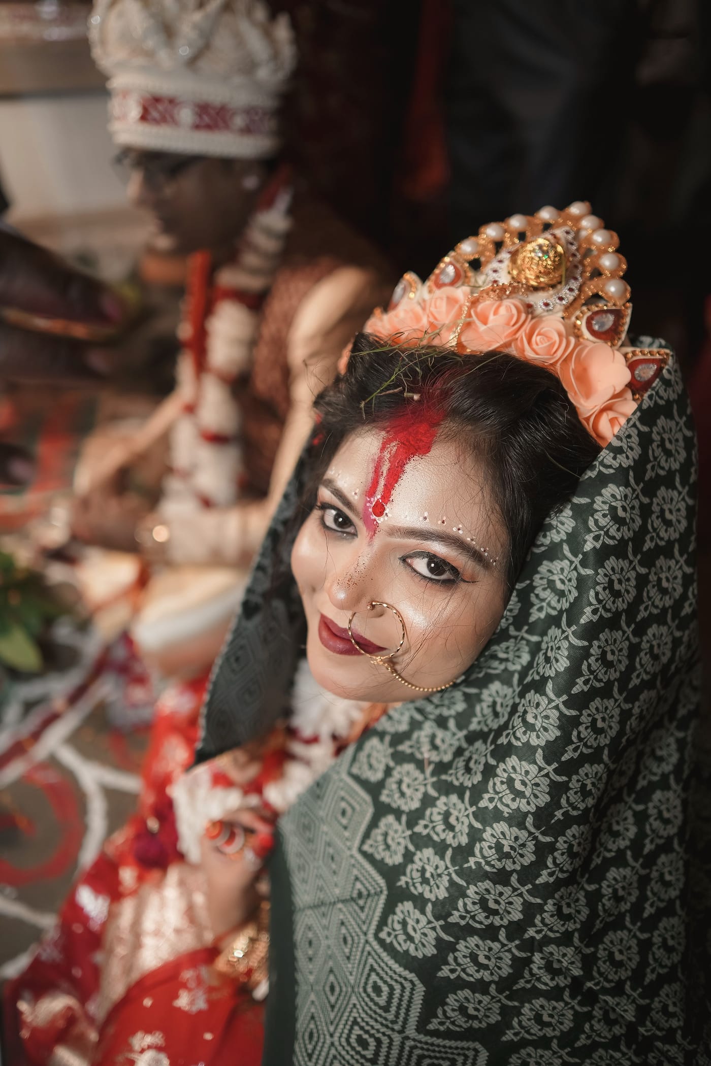 A close portrait of the bride in a green shawl